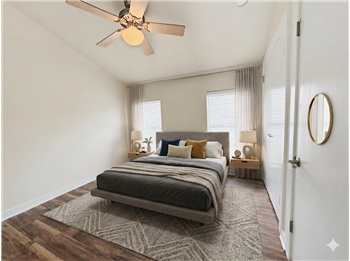 Virtually staged secondary bedroom with vaulted ceilings.
