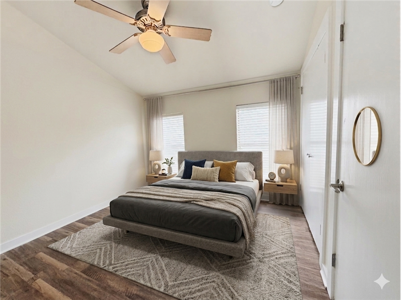 Virtually staged secondary bedroom with vaulted ceilings.
