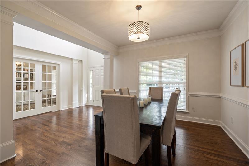 Dining room with open sight lines to foyer and study/living room