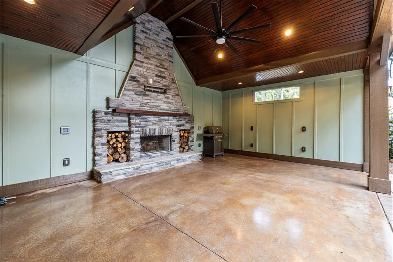 Cabana offers spacious indoor/outdoor entertaining space, featuring stacked stone fireplace, vaulted ceiling, TV mount