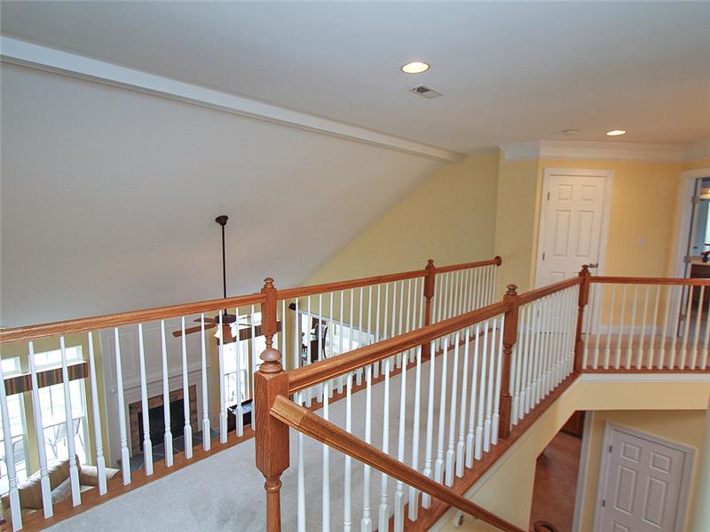 Upstairs catwalk separates secondary bedroom wings