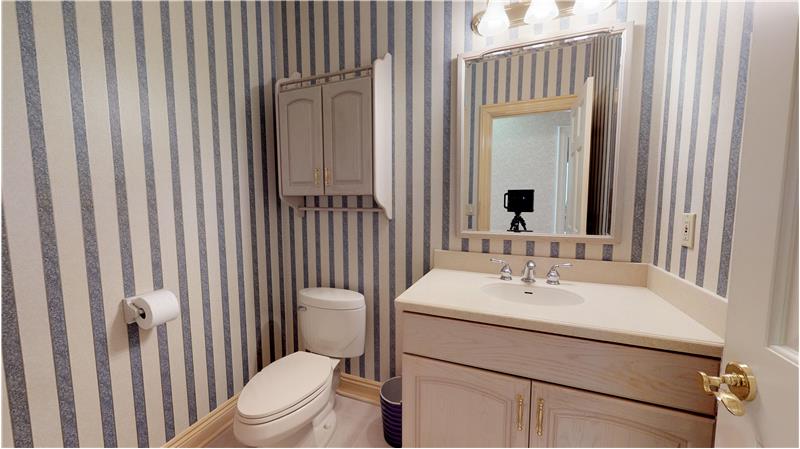 Half bath located off the kitchen.