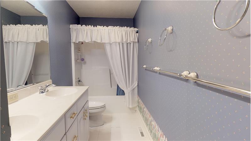 Second full bath with ceramic tiled floor on the second floor adjacent to bedrooms 3 and 4.