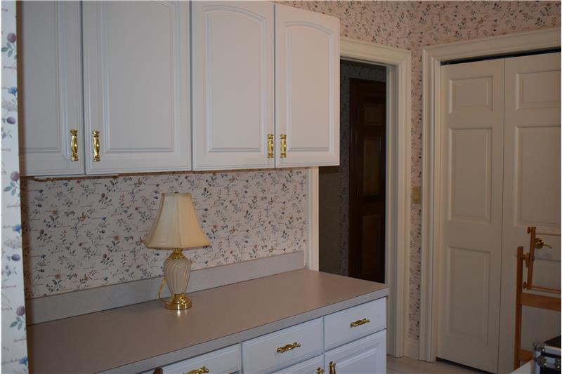 Cabinets opposite the washer and dryer.