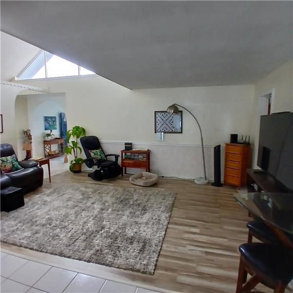 Family room with foyer to the left and additional bedrooms to the left