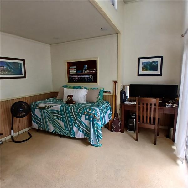Larger bedroom off family room with sliding glass door