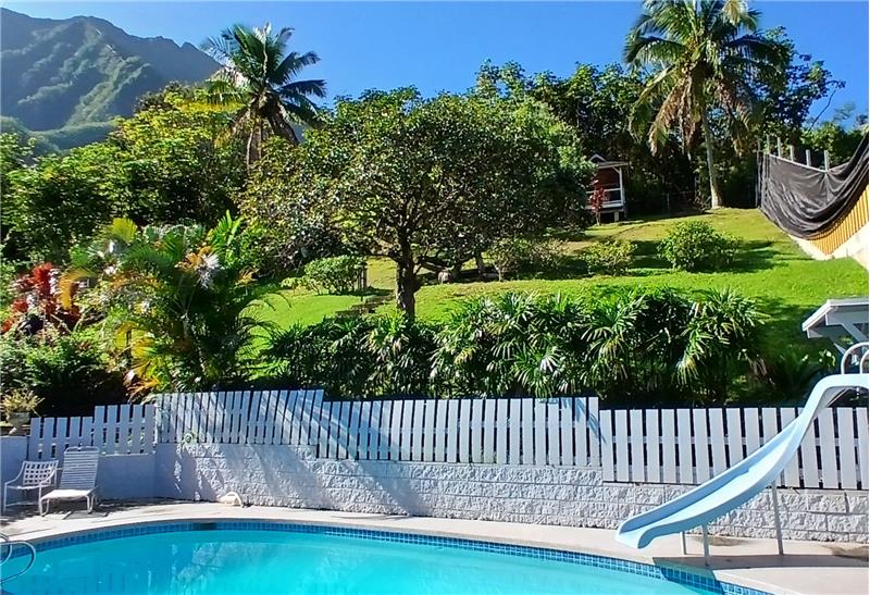 Fenced in backyard with pool area