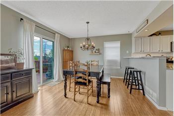 The Dining Room features bamboo flooring, a breakfast bar overlooking the kitchen, and slider out to the backyard deck.