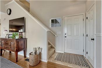 Entry with ceramic tile floor and coat closet.
