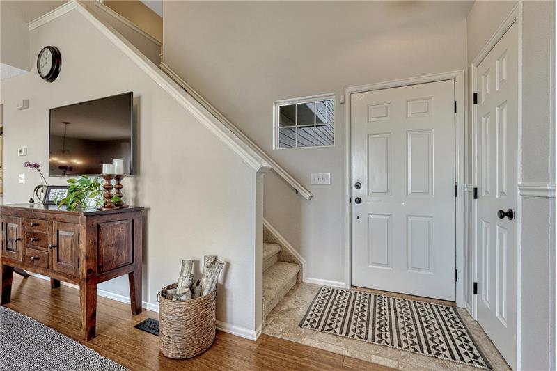 Entry with ceramic tile floor and coat closet.