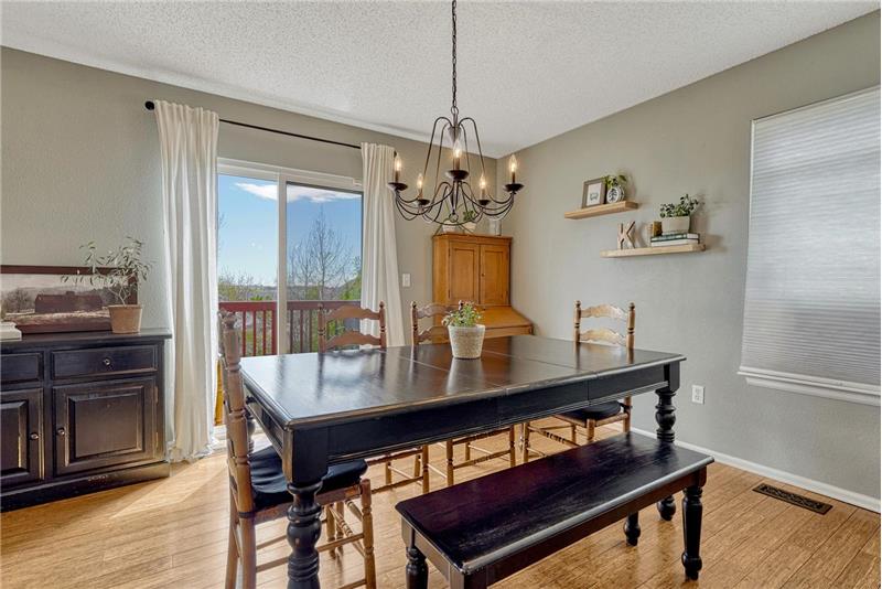 The Dining Room offers an attractive light fixture and sliding door out to the backyard deck.