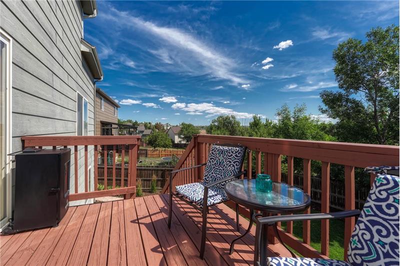 The backyard deck has stairs to the backyard.