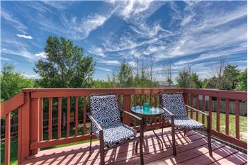 The backyard deck overlooks the beautiful yard with mature trees & shrubs.