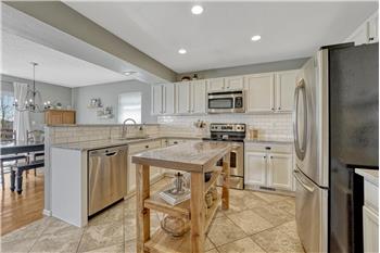 Stainless steel appliances incl a range oven, microwave, dishwasher, & French door refrigerator.