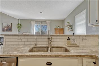 Gorgeous subway tile backsplash and undermount stainless steel sink.