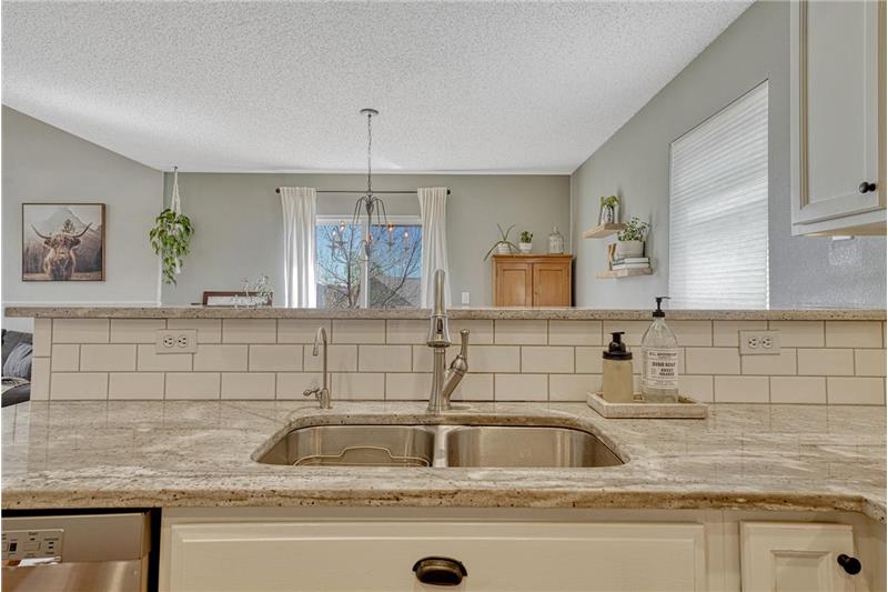 Gorgeous subway tile backsplash and undermount stainless steel sink.