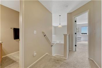 Upper level hallway with entrance to the upper level bathroom and Primary Bedroom.