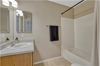 Upper Level Full Bathroom with vanity, medicine cabinet, and tiled tub/shower.