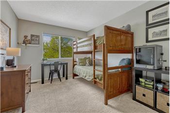 Upper Level Bedroom with neutral carpet.