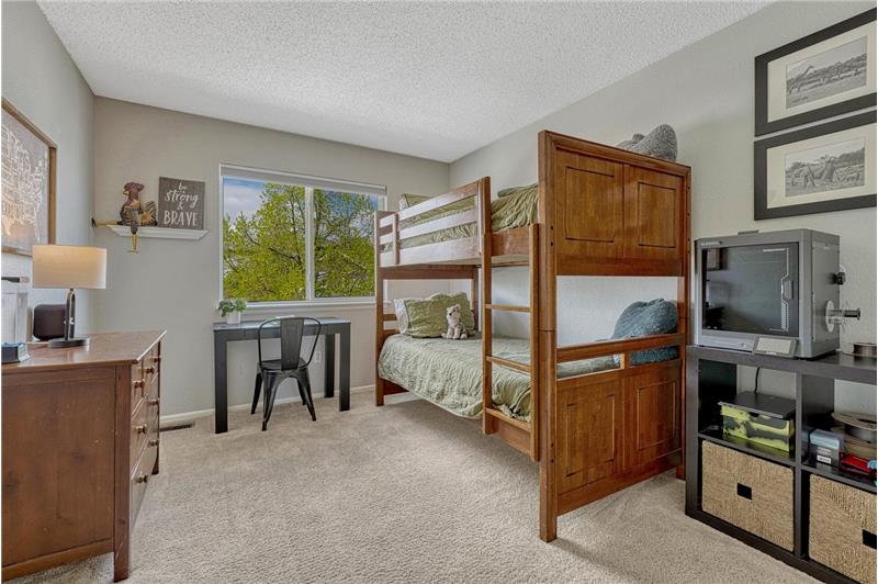 Upper Level Bedroom with neutral carpet.