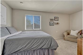 Spacious Lower Level Bedroom with neutral carpet and sitting area.