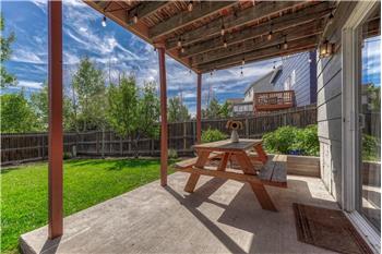 Covered concrete patio with lights.
