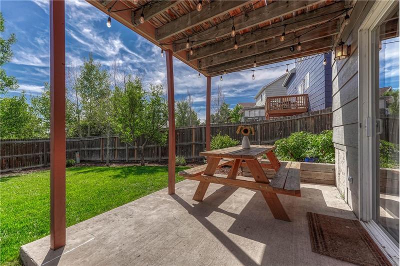 Covered concrete patio with lights.