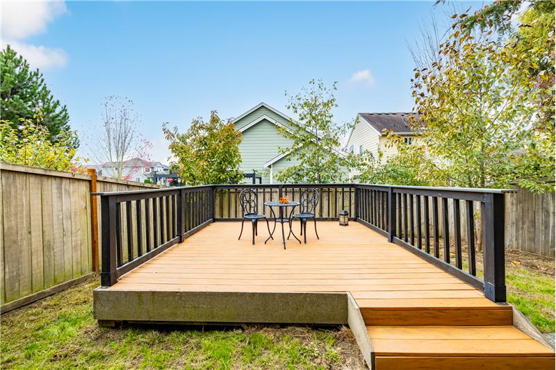 Raised deck in the fully fenced back yard