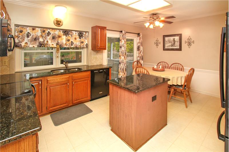 Kitchen updated with granite counters and tile flooring