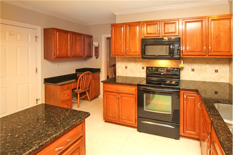 More cabinetry in desk area