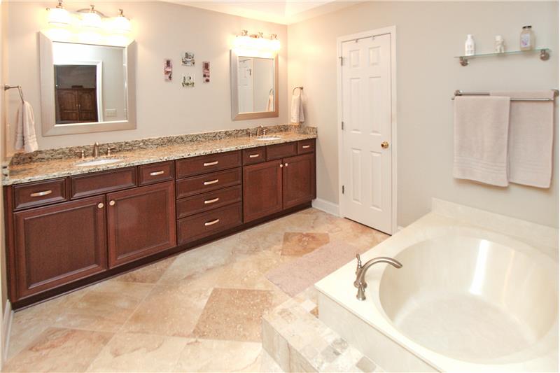 Primary bathroom with travertine tile