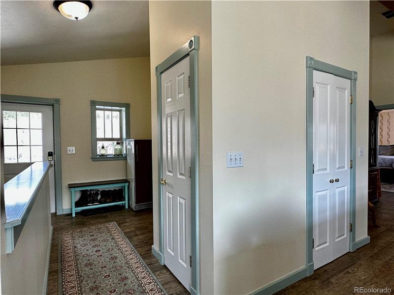 View of foyer, coat closet and kitchen pantry