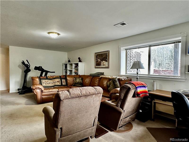 View of family room from bottom of stairs