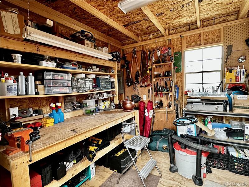 The workbench, vise and pegboards are included