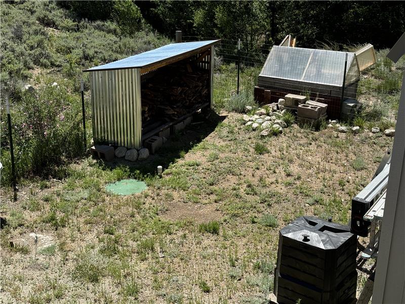 Dog run has woodshed. Septic tank covers are visible