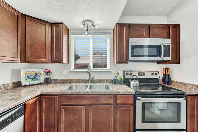There are Ample Cabinets w/ Granite Look Countertops