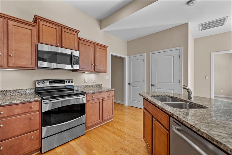 Kitchen includes stainless steel appliances, pantry, hardwood floors