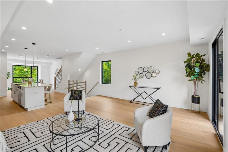 Bright and spacious living room with an open-concept layout leading directly into the kitchen.