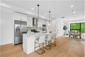 Gourmet kitchen with high-end appliances, custom cabinetry, and premium stone countertops.