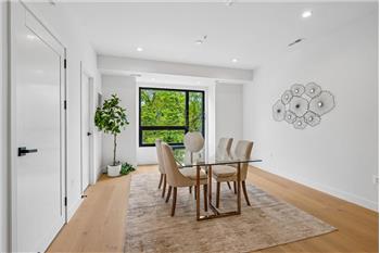 The dining room flows seamlessly into the kitchen, featuring an adjacent half bathroom for added convenience.