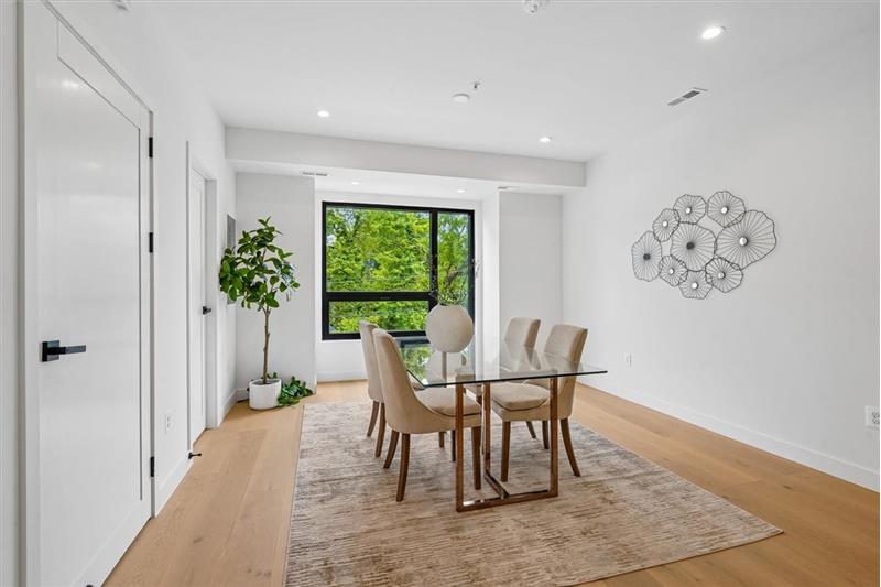 The dining room flows seamlessly into the kitchen, featuring an adjacent half bathroom for added convenience.