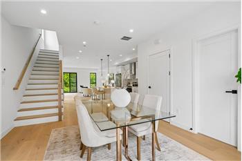Open-concept layout featuring a dining room that flows seamlessly into the kitchen and