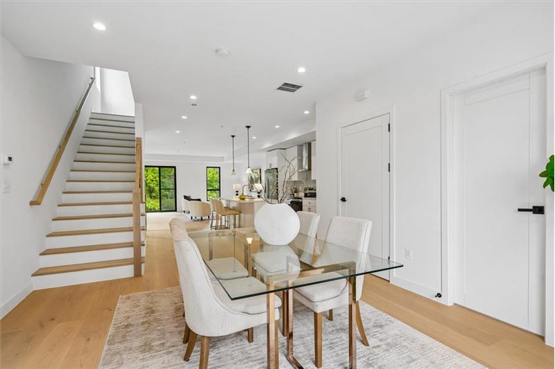 Open-concept layout featuring a dining room that flows seamlessly into the kitchen and