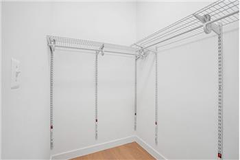 This light-filled and exceptionally spacious primary bedroom w/ large walk-in closet