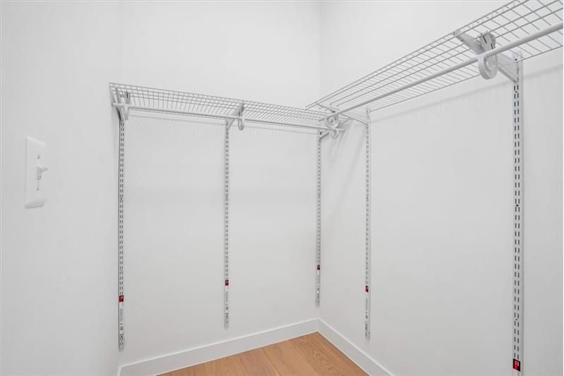 This light-filled and exceptionally spacious primary bedroom w/ large walk-in closet