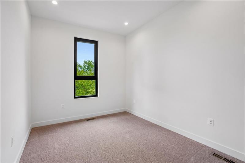 This generously sized and light-filled second bedroom is conveniently located on the top floor.