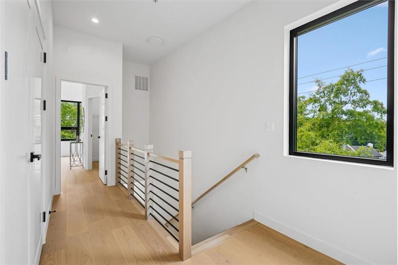 Bright and airy top-floor landing with ample space & laundry.