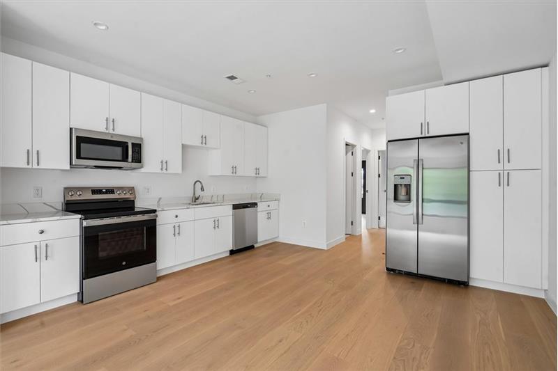 Spacious open-concept kitchen featuring modern finishes, perfect for cooking and entertaining. - Rental Unit
