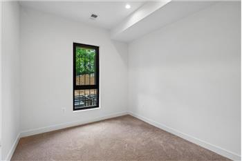 Cozy and spacious bedroom featuring large windows, plenty of natural light, and ample closet space in a prime l