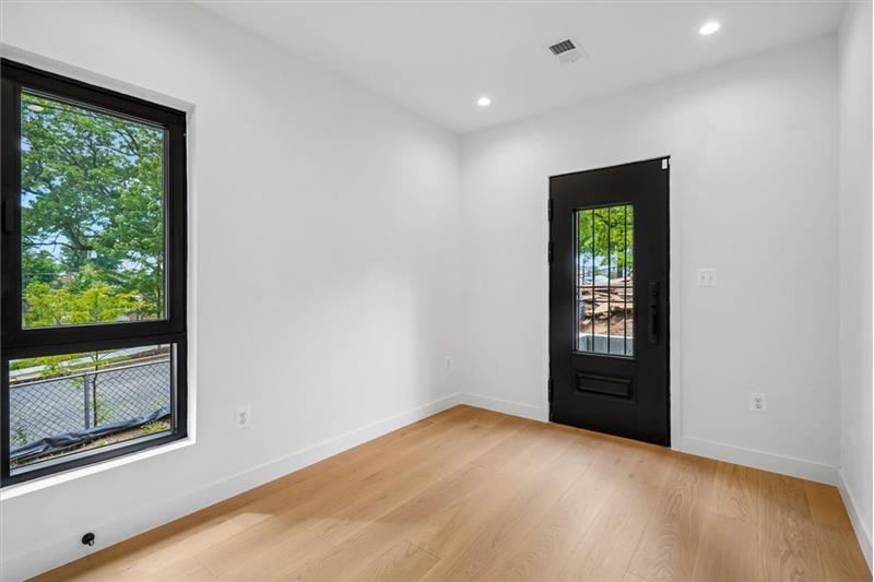 Bedroom 2 with balcony and access to rear yard